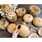 This image shows unfinished gourds with their tops cut off. The gourds are dried and ready for carving.